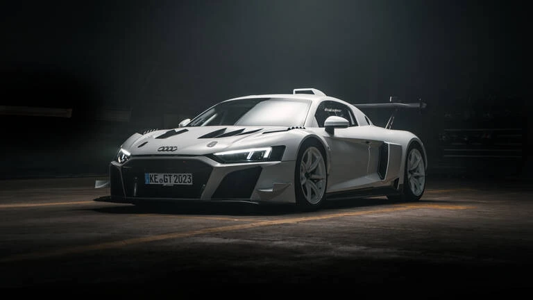 Gray ABT XGT photographed from the front three-quarter angle in a dark setting.