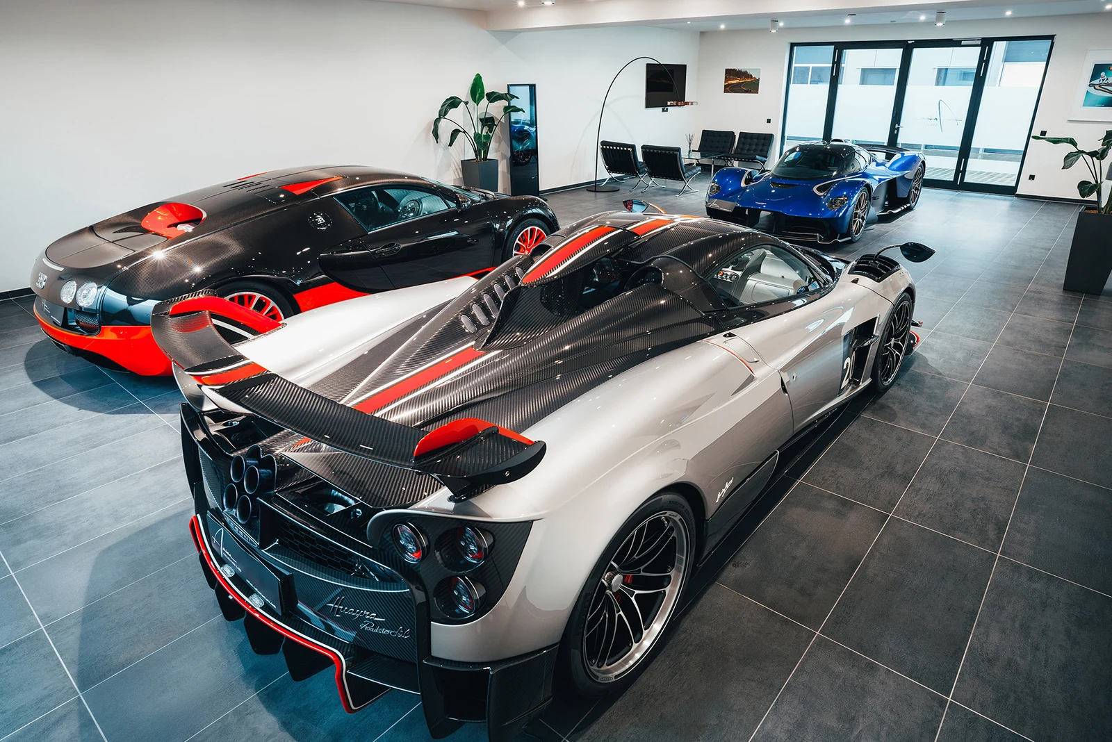Pagani Huayra Roadster BC, Bugatti Veyron, and Aston Martin Valkyrie in the Amian Collection Cars showroom in Kerpen.