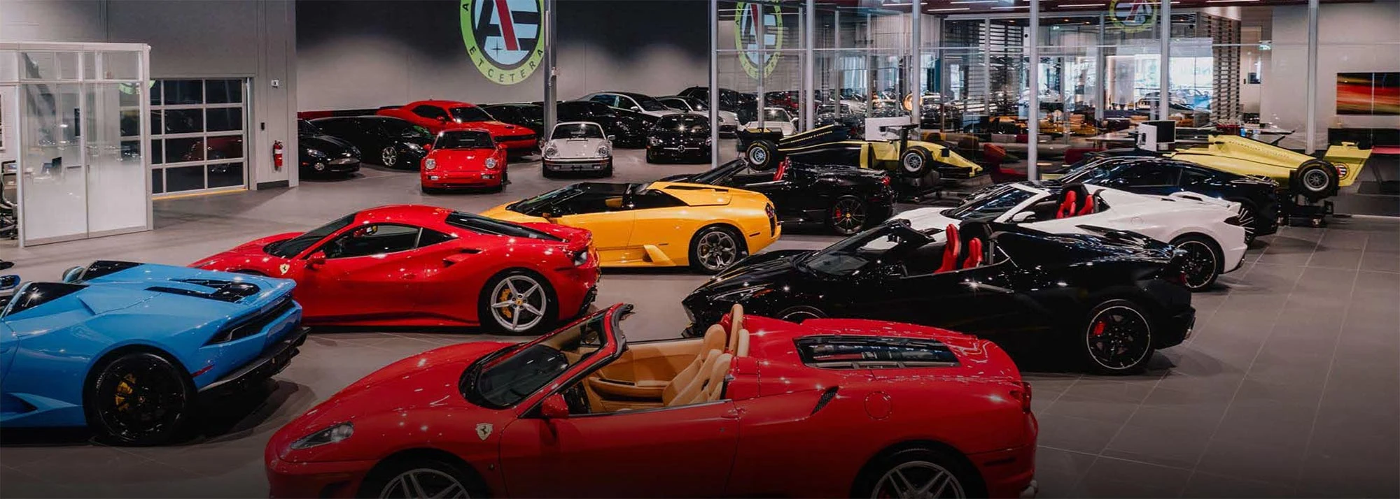 Automobiles Etcetera showroom in Mount Royal, with Ferrari, Lamborghini and Porsche cars lined up.