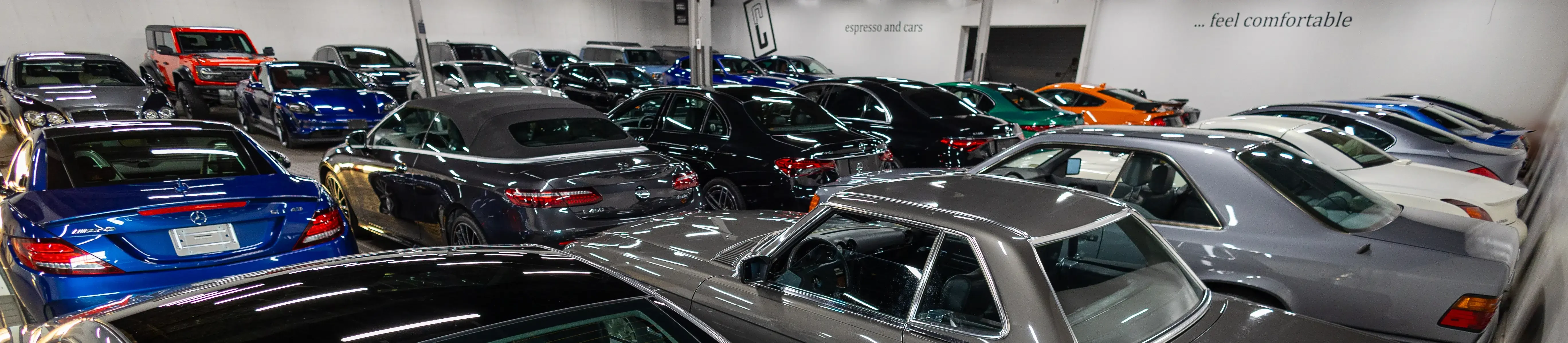 Car Lounge indoor showroom in Oakville, with Mercedes-Benz, Porsche and classic cars on display.