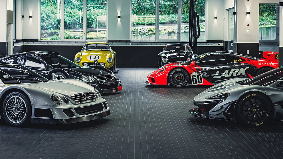 Collection of Mercedes-Benz, Ferrari and McLaren sports cars in the Mechatronik showroom.