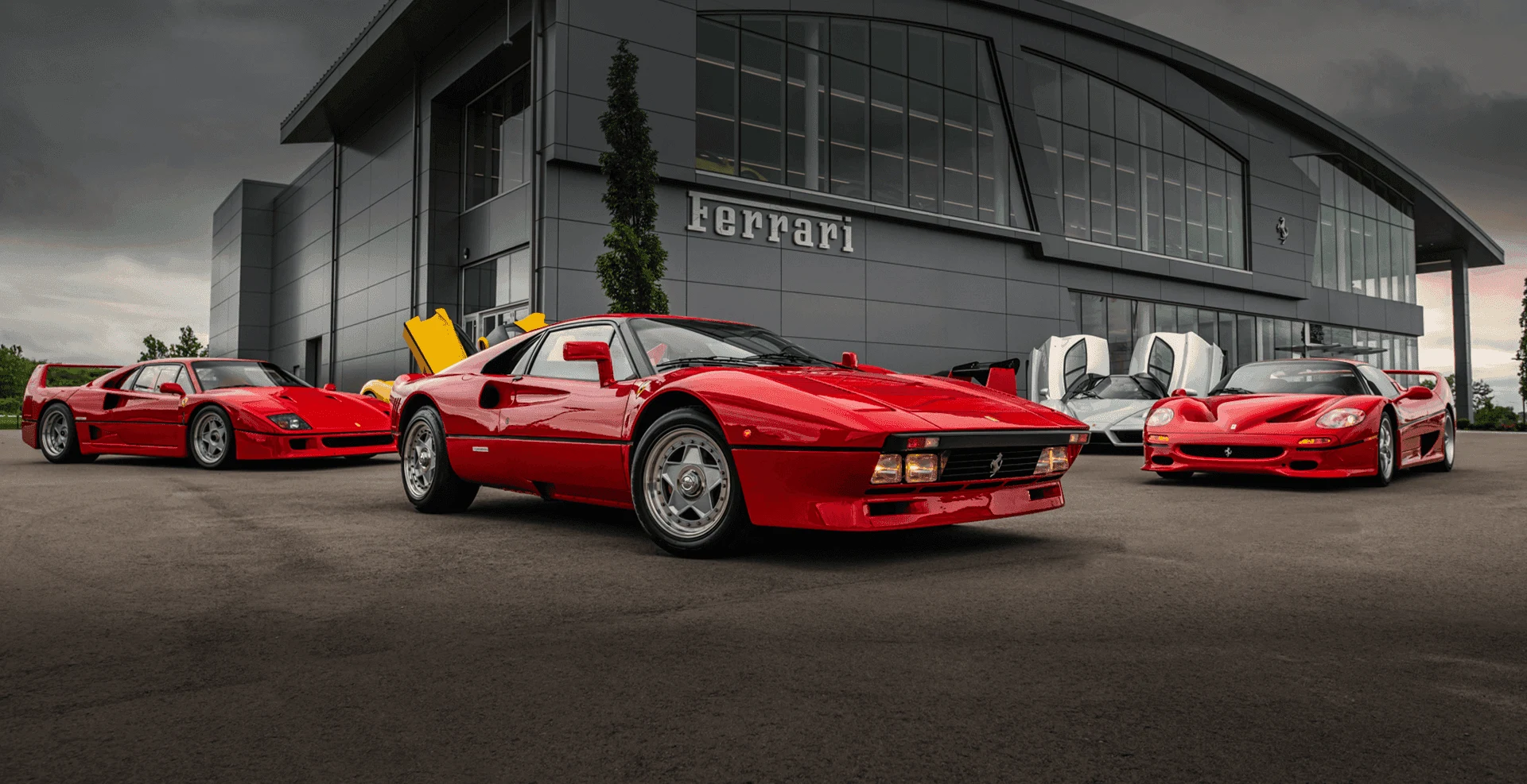 Classic and modern Ferrari cars, with a red 308 in the foreground, outside the Prancing Horse of Nashville showroom.