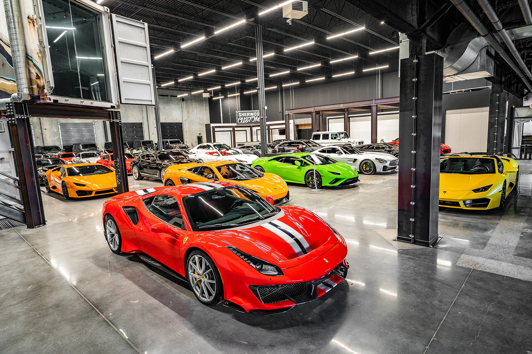 Sherwood Motorcars showroom in Sherwood Park, with a Ferrari 488 Pista in front of Lamborghini, McLaren and Mercedes-AMG cars.