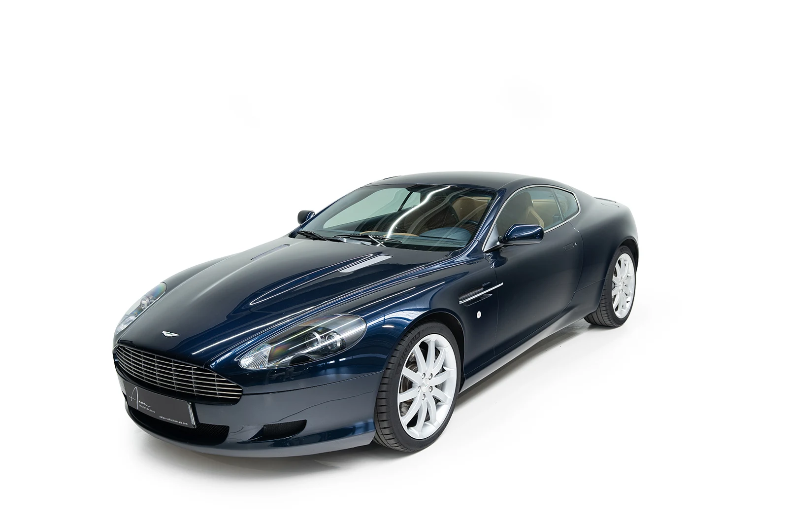 Blue Aston Martin DB9, full front three-quarter view