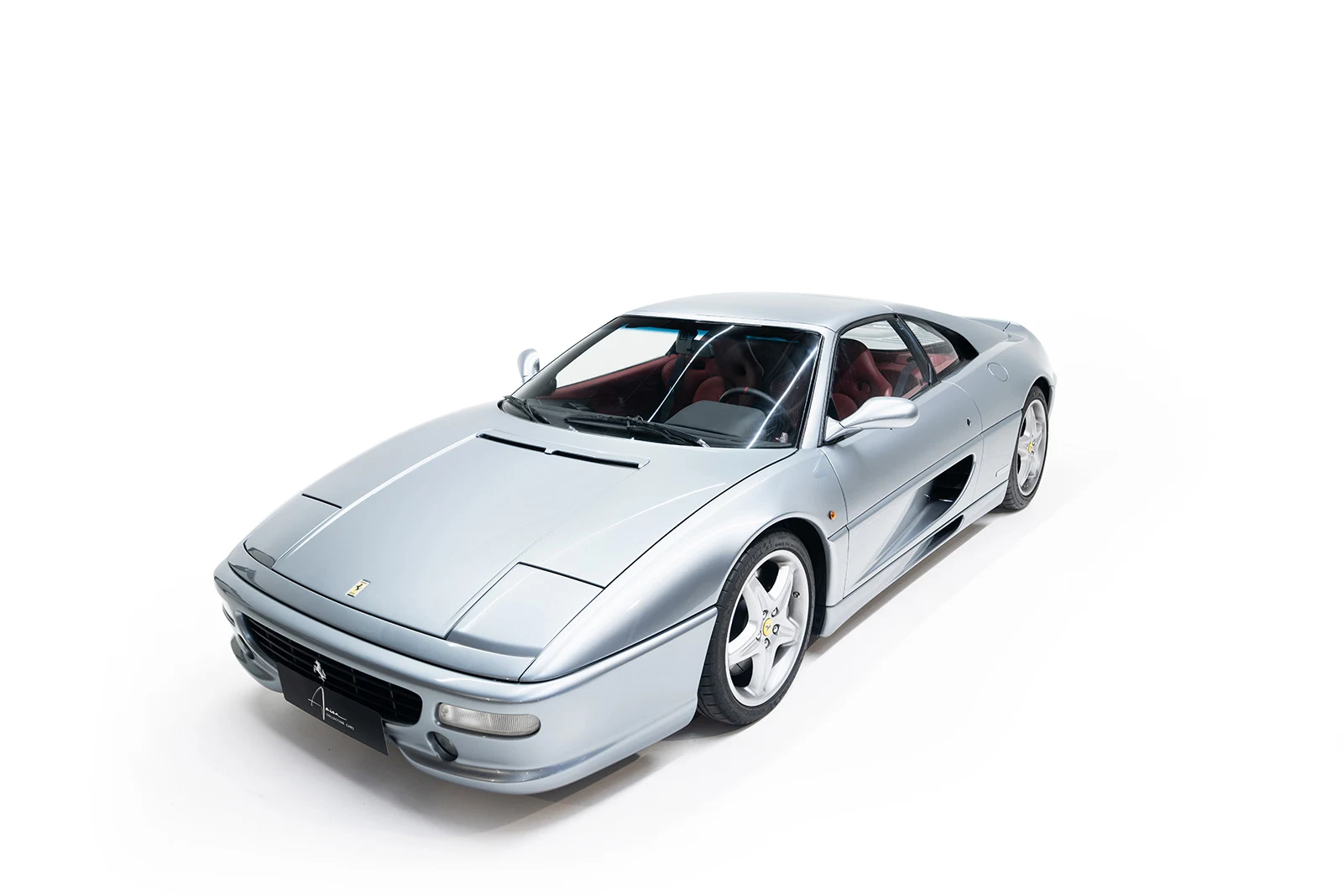 Silver Ferrari F355 GTS, full front three-quarter view