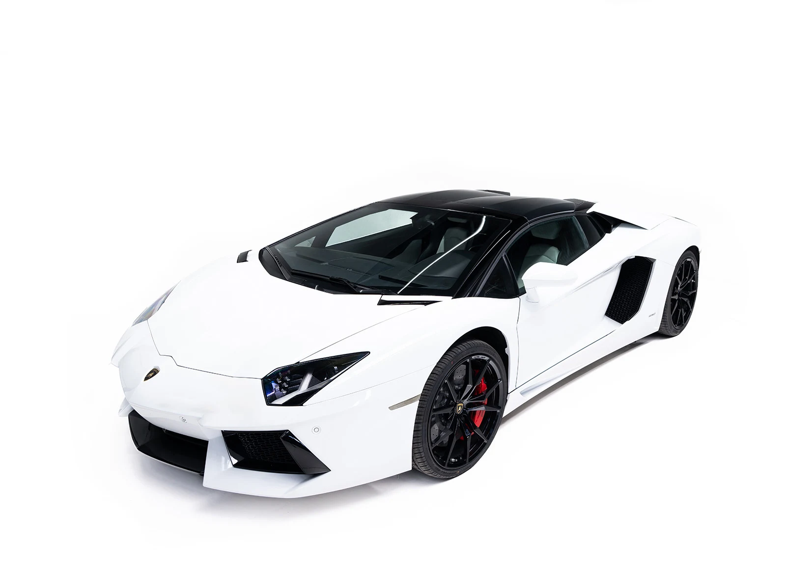 White Lamborghini Aventador Roadster, full front three-quarter view
