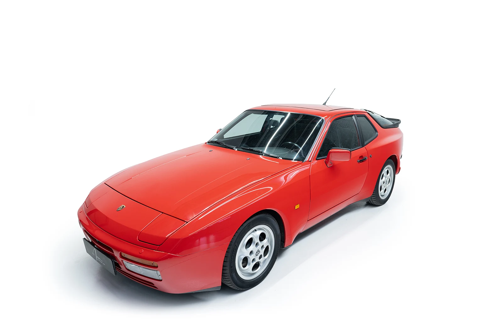 Red Porsche 944 Turbo, full front three-quarter view