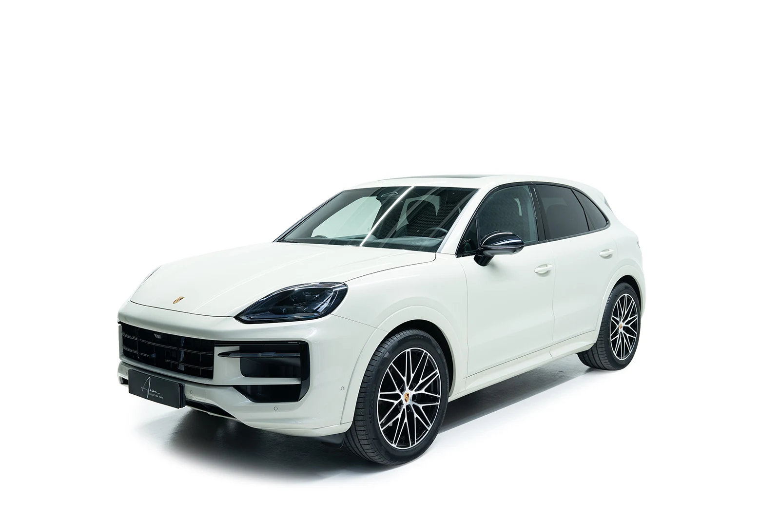 Light gray Porsche Cayenne, full front three-quarter view