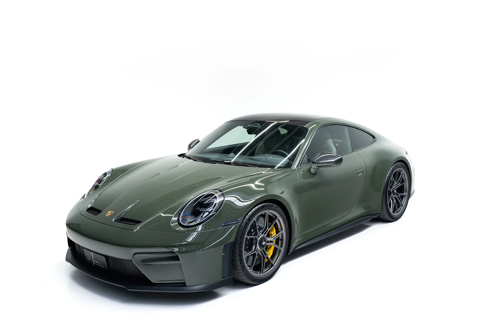 Dark olive Porsche 911 GT3 Touring, full front three-quarter view