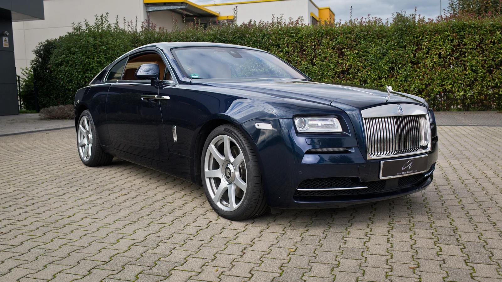 Midnight blue Rolls-Royce Wraith, full front three-quarter view