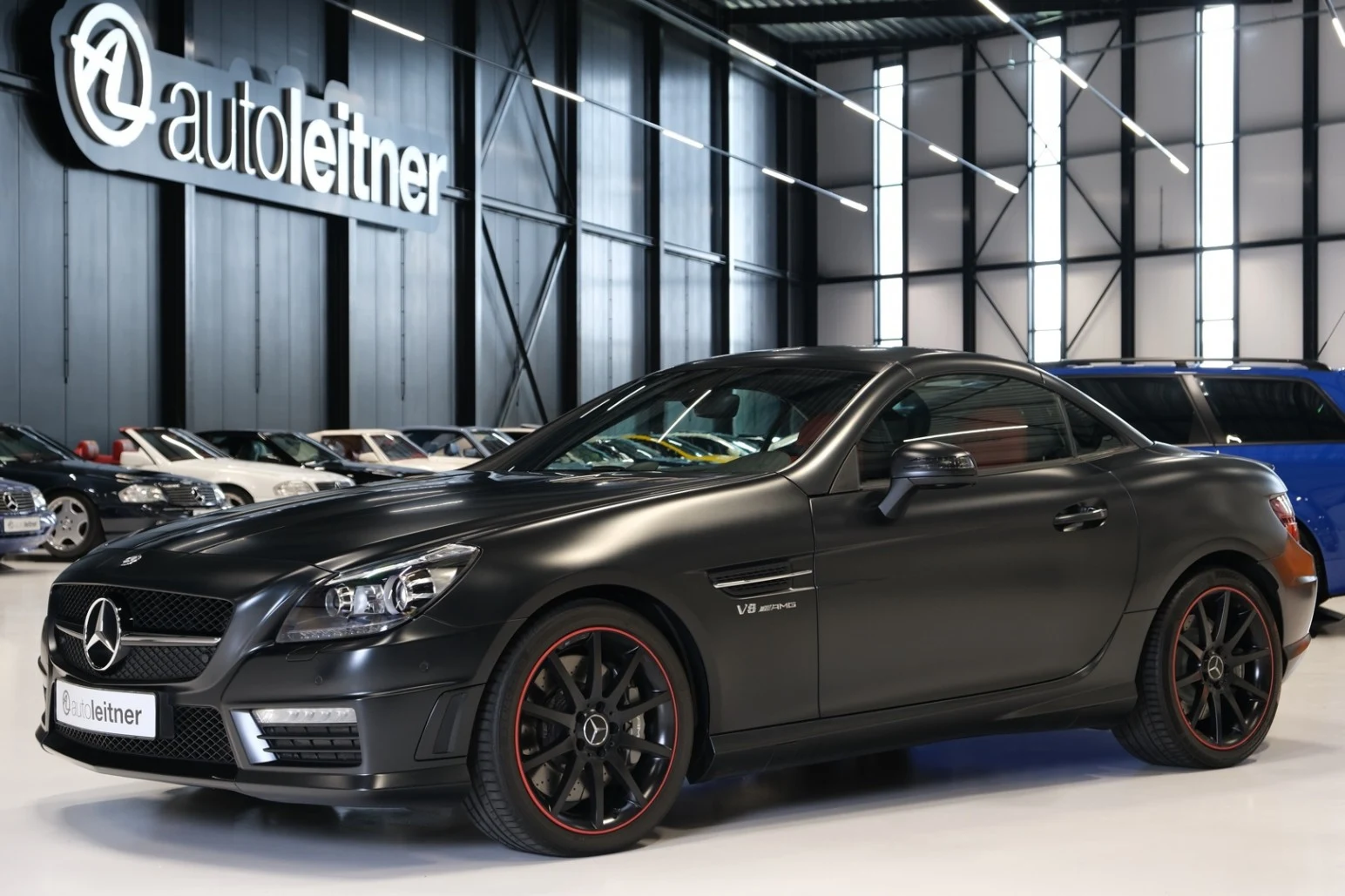 Matte black Mercedes-AMG SLK 55, full front three-quarter view
