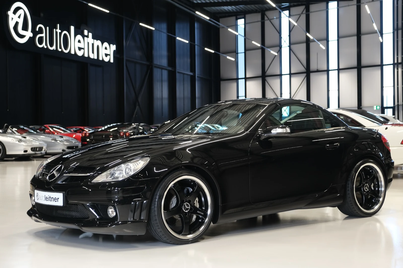 Black Mercedes-AMG SLK 55, full front three-quarter view