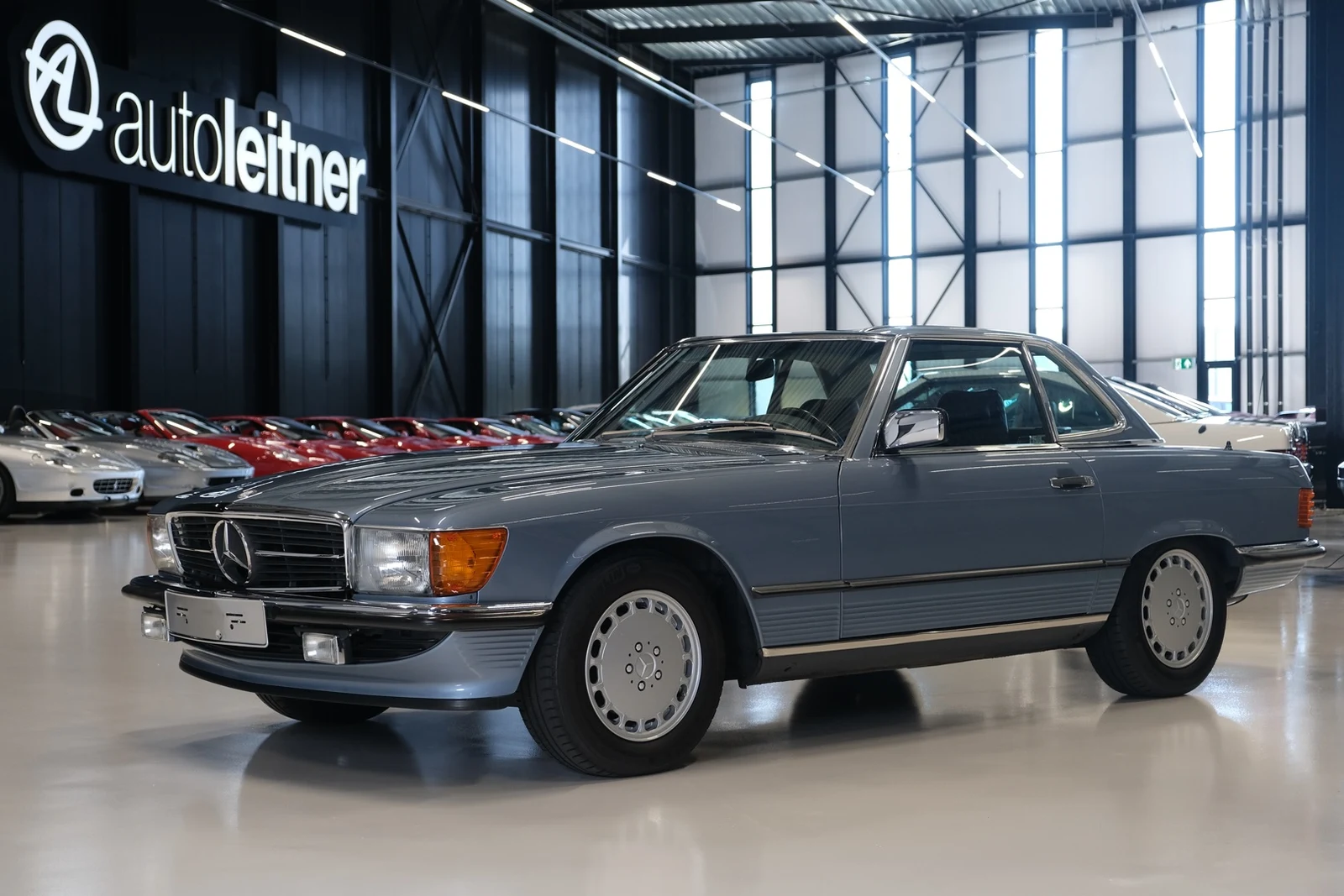 Blue Mercedes-Benz 300 SL R107, full front three-quarter view