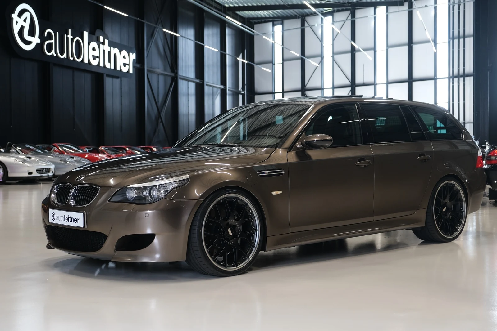 Bronze BMW M5 Touring, full front three-quarter view