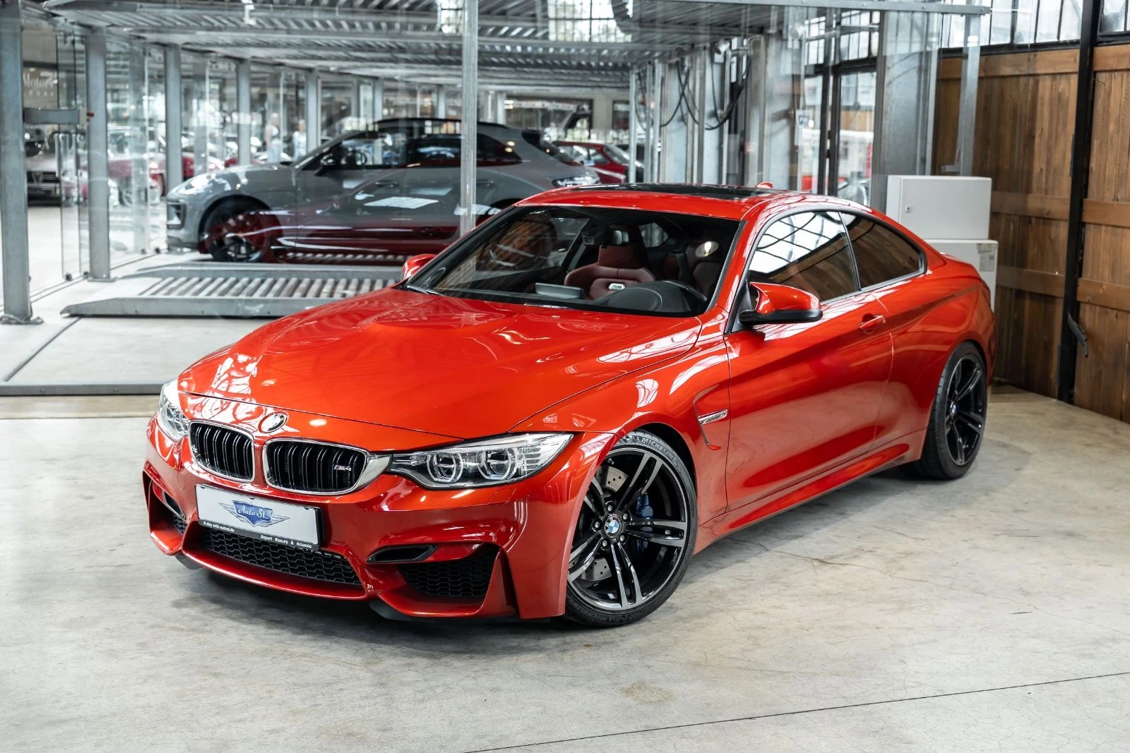 Orange BMW M4 Coupe, full front three-quarter view