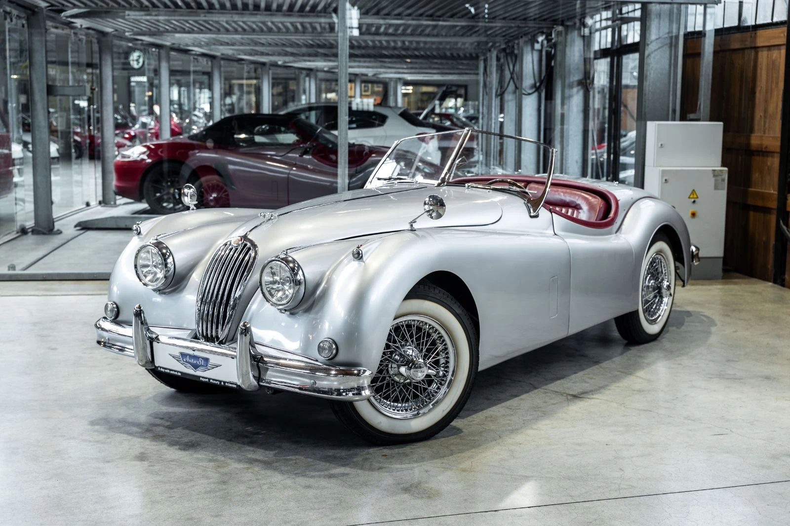Silver Jaguar XK140, full front three-quarter view