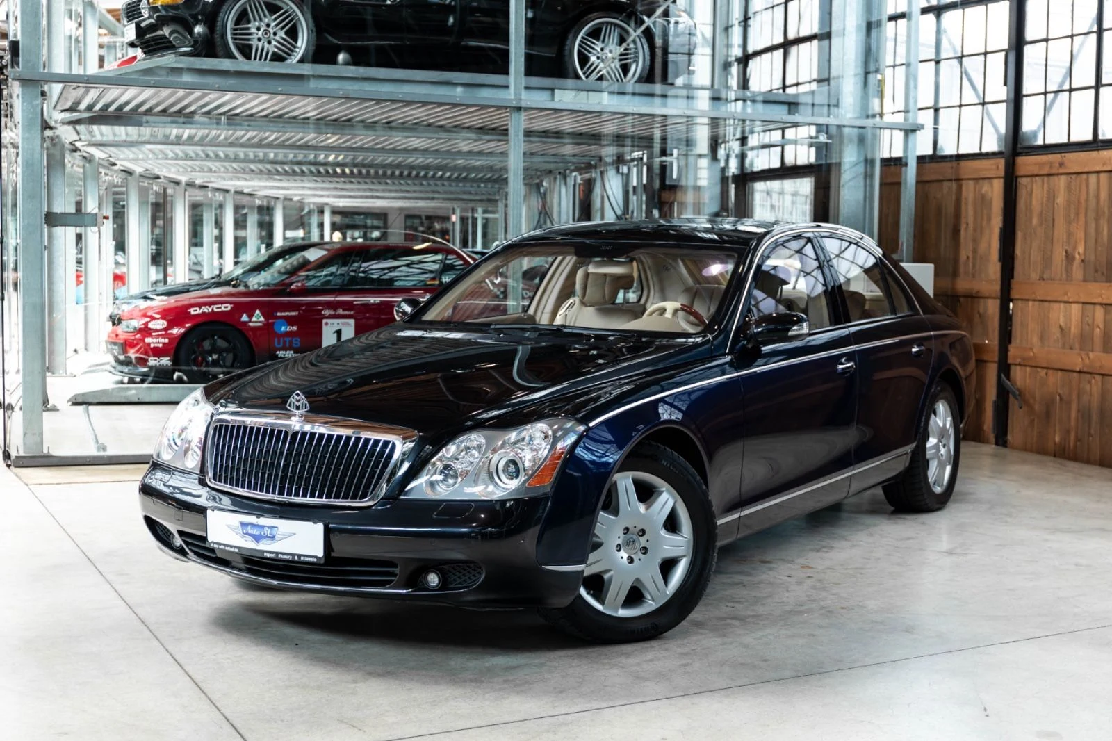 Blue and black Maybach 57, full front three-quarter view