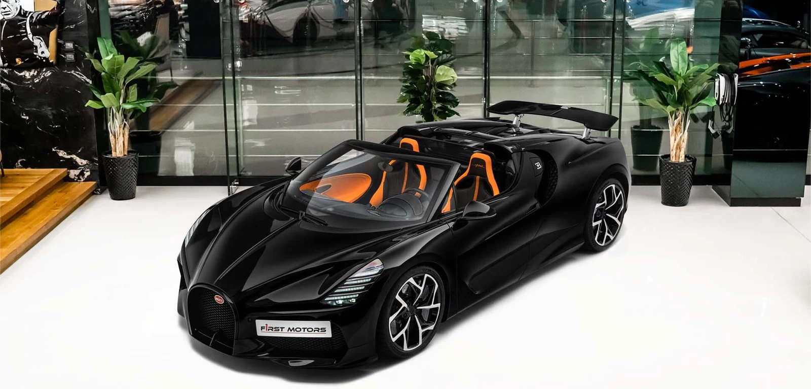 Black Bugatti W16 Mistral with orange cabin, front three-quarter view