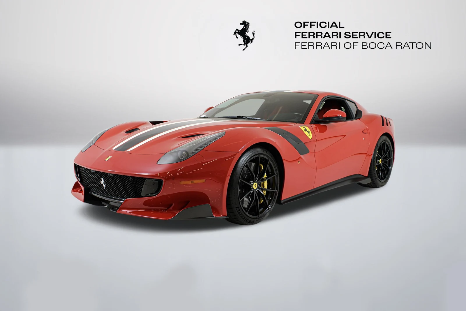 Rosso Corsa Ferrari F12tdf in a front three-quarter view