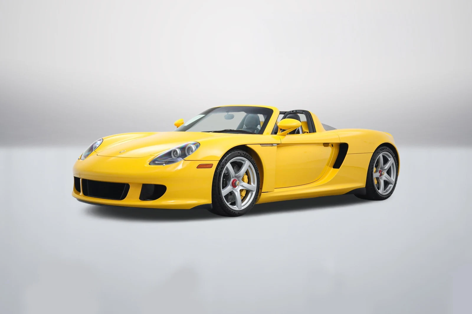 Fayence Yellow Porsche Carrera GT in a front three-quarter view