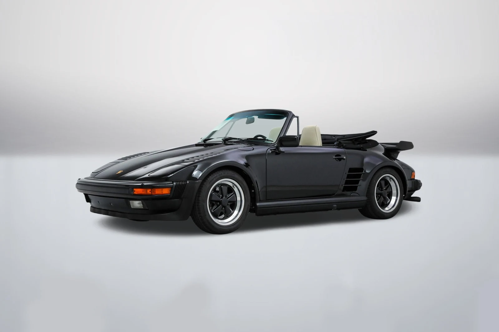 Black Porsche 911 (930) Turbo Cabriolet Slantnose in a front three-quarter view