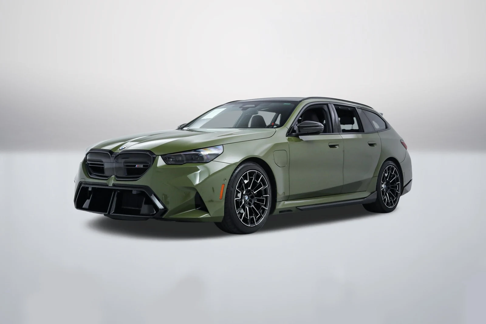 Urban Green BMW M5 Touring (G99) in a front three-quarter view
