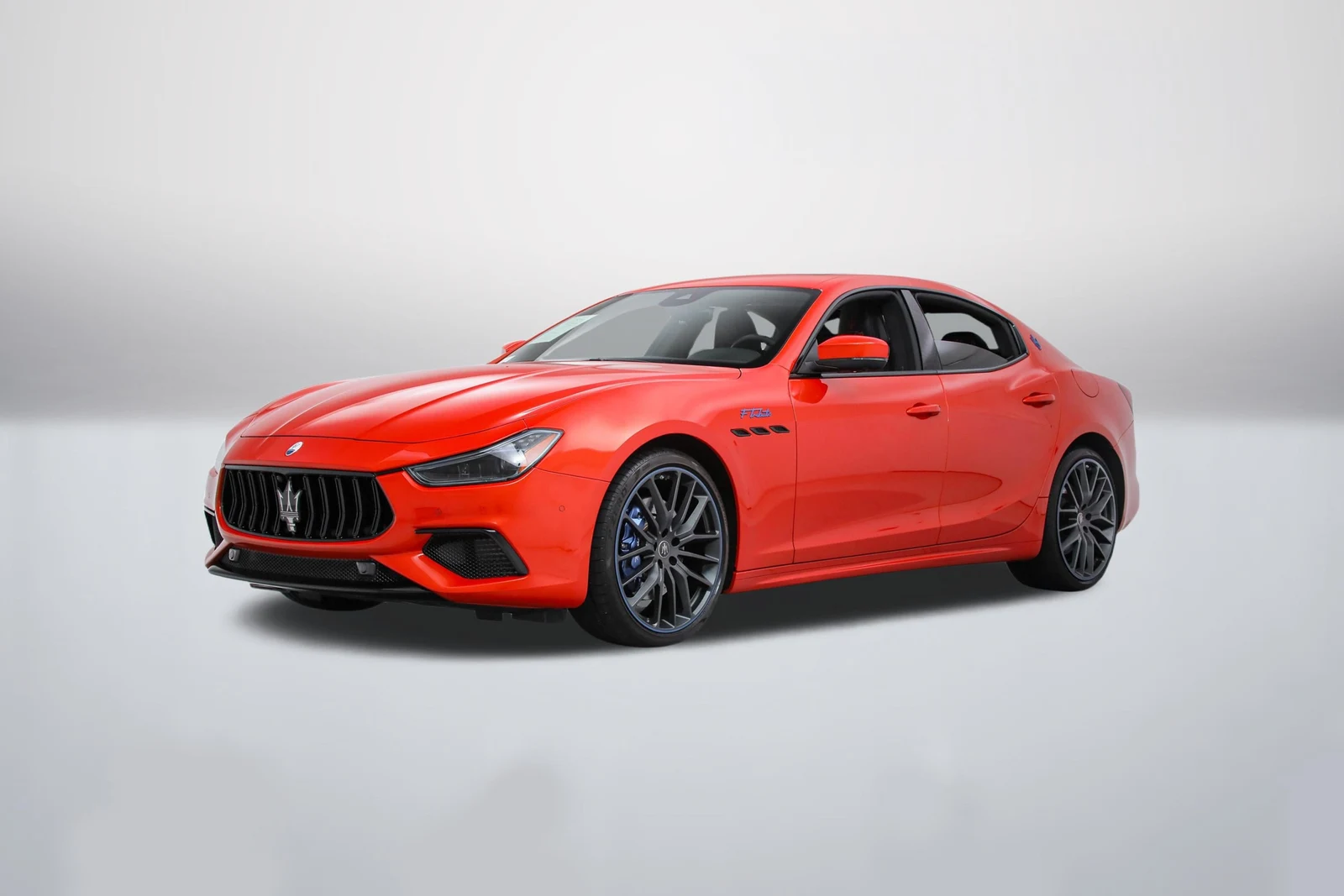 Orange Devil Maserati Ghibli Modena F Tributo Q4 in a front three-quarter view