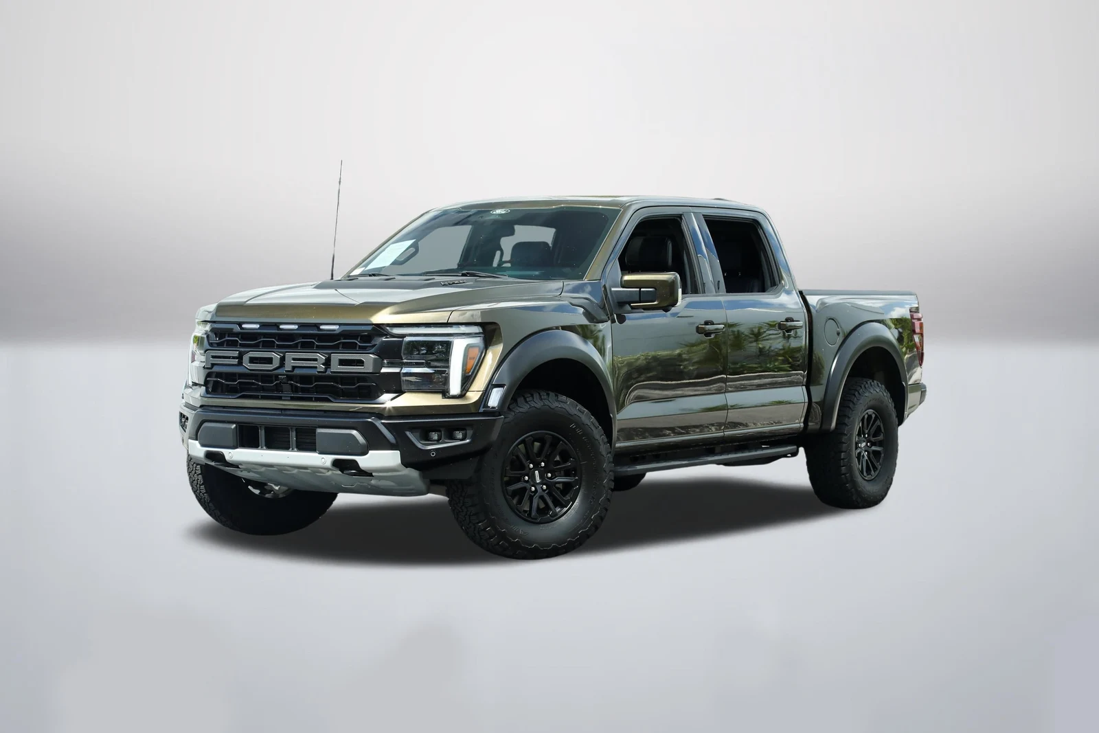 Shelter Green Ford F-150 Raptor in a front three-quarter view