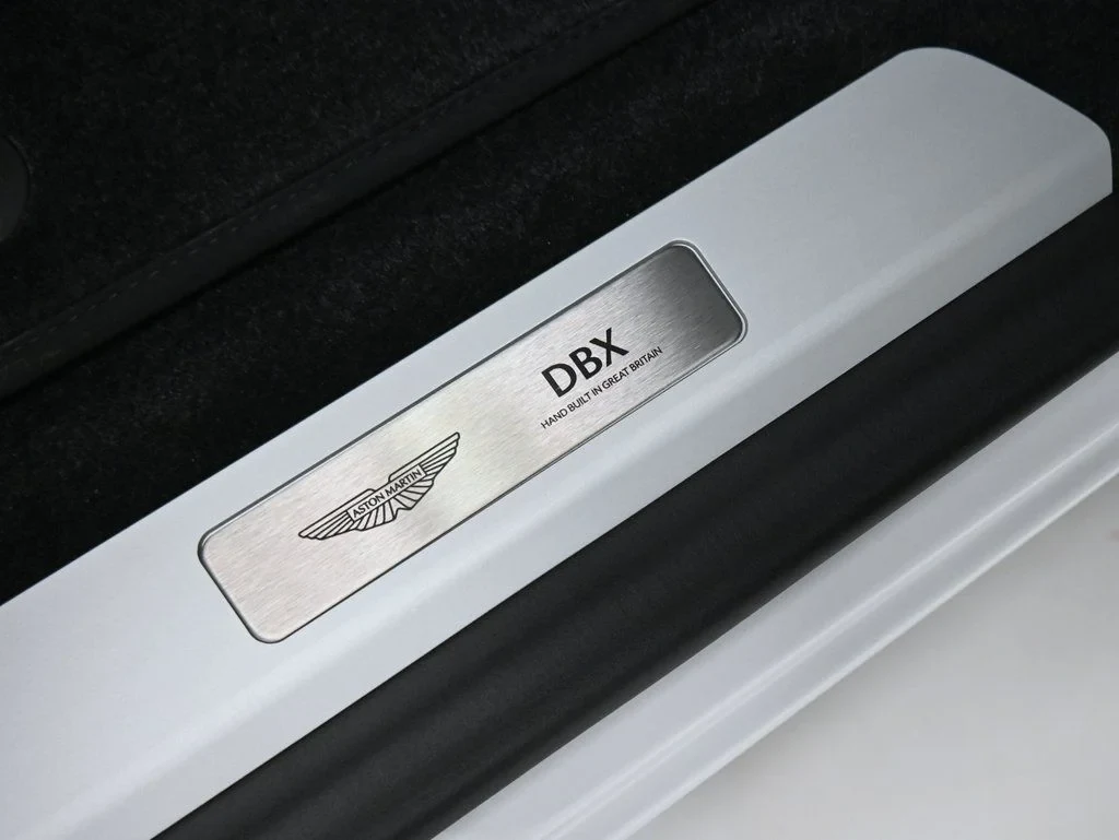 2026 Aston Martin DBX 707 interior, door sill, Black Metallic with Spicy Red Stitching