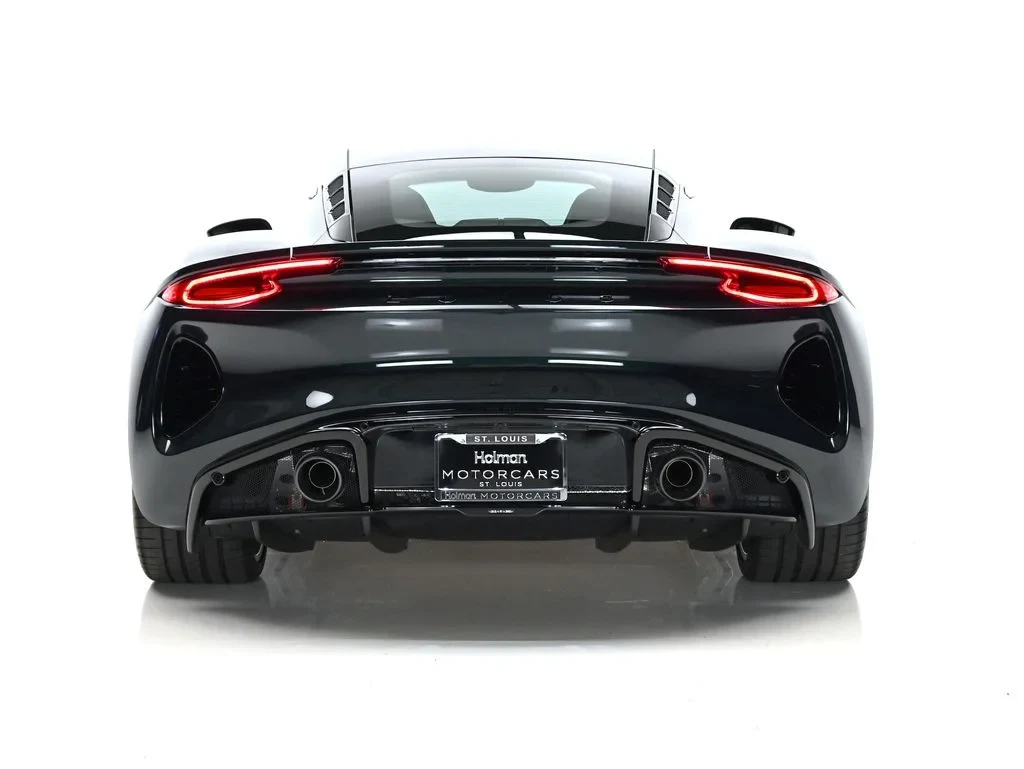 2026 Lotus Emira Turbo SE, rear three-quarter view, Dark Verdant