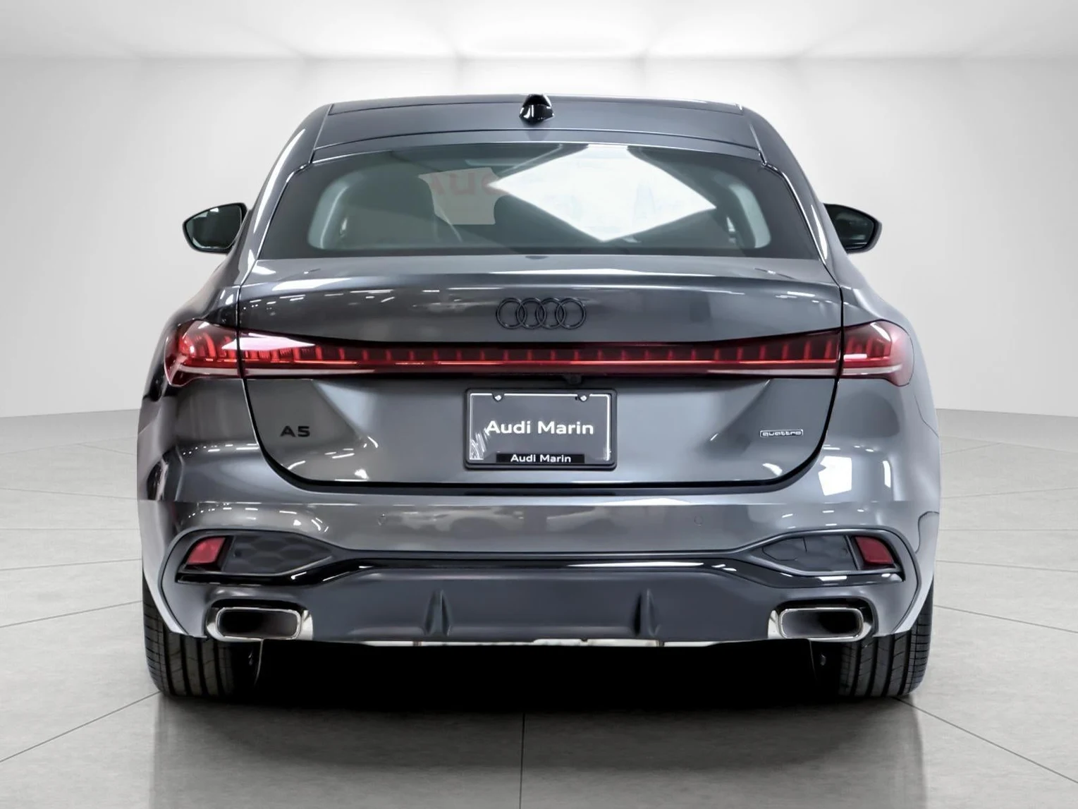 2026 Audi A5 Premium Plus, rear three-quarter view, Daytona Gray Pearl Effect