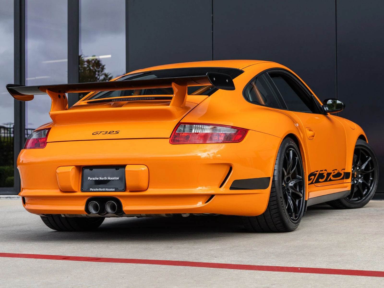 2007 Porsche 911 GT3 RS, rear three-quarter view, Orange with contrasting Black
