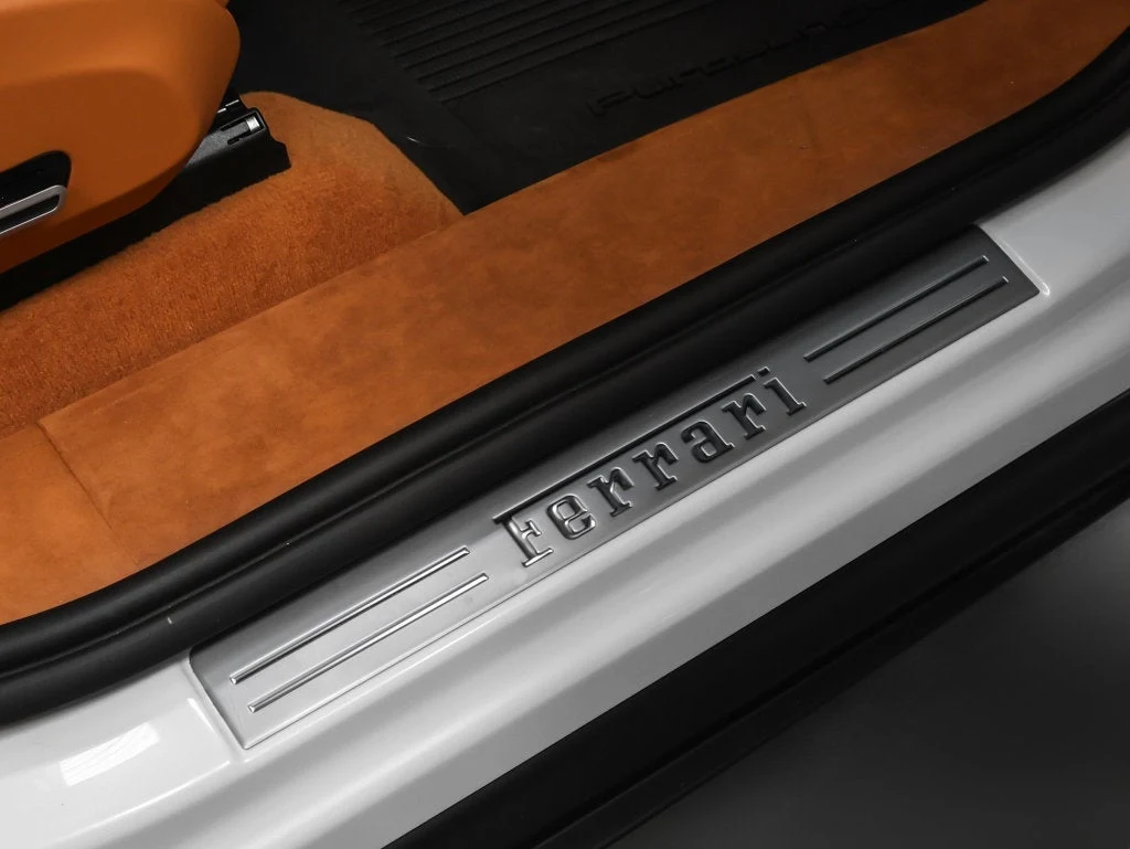 2026 Ferrari Purosangue interior, door sill, Cuoio leather with Iroko accents