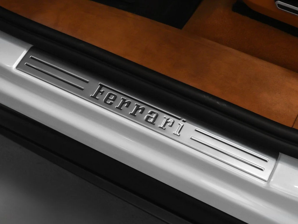 2026 Ferrari Purosangue interior, door sill, Cuoio leather with Iroko accents