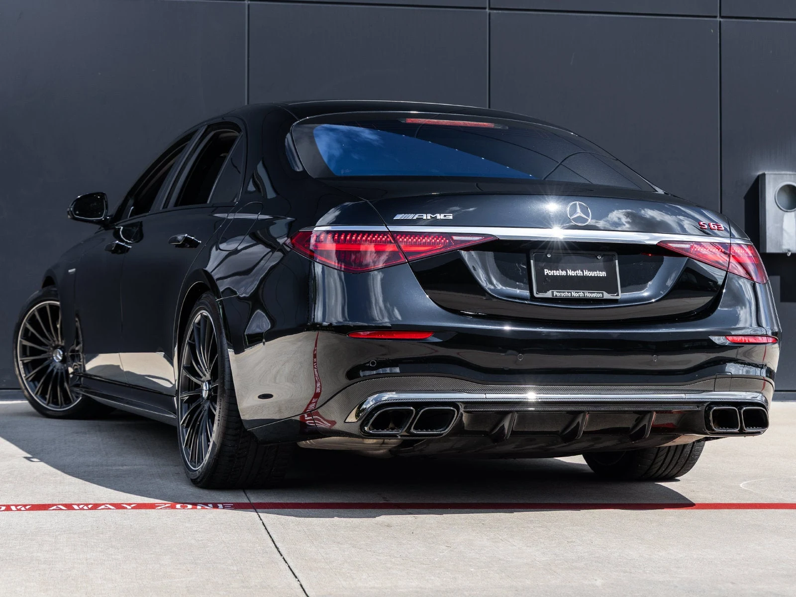 2024 Mercedes-AMG S 63 E PERFORMANCE, rear three-quarter view, Black