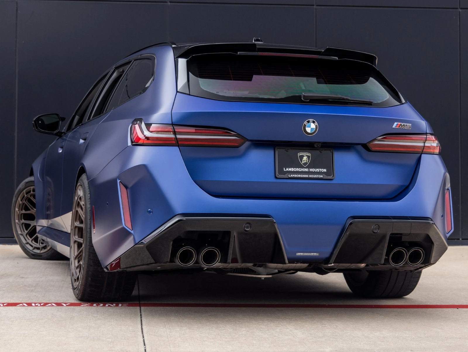 2026 BMW M5 Touring, rear three-quarter view, Marina Bay Blue Metallic