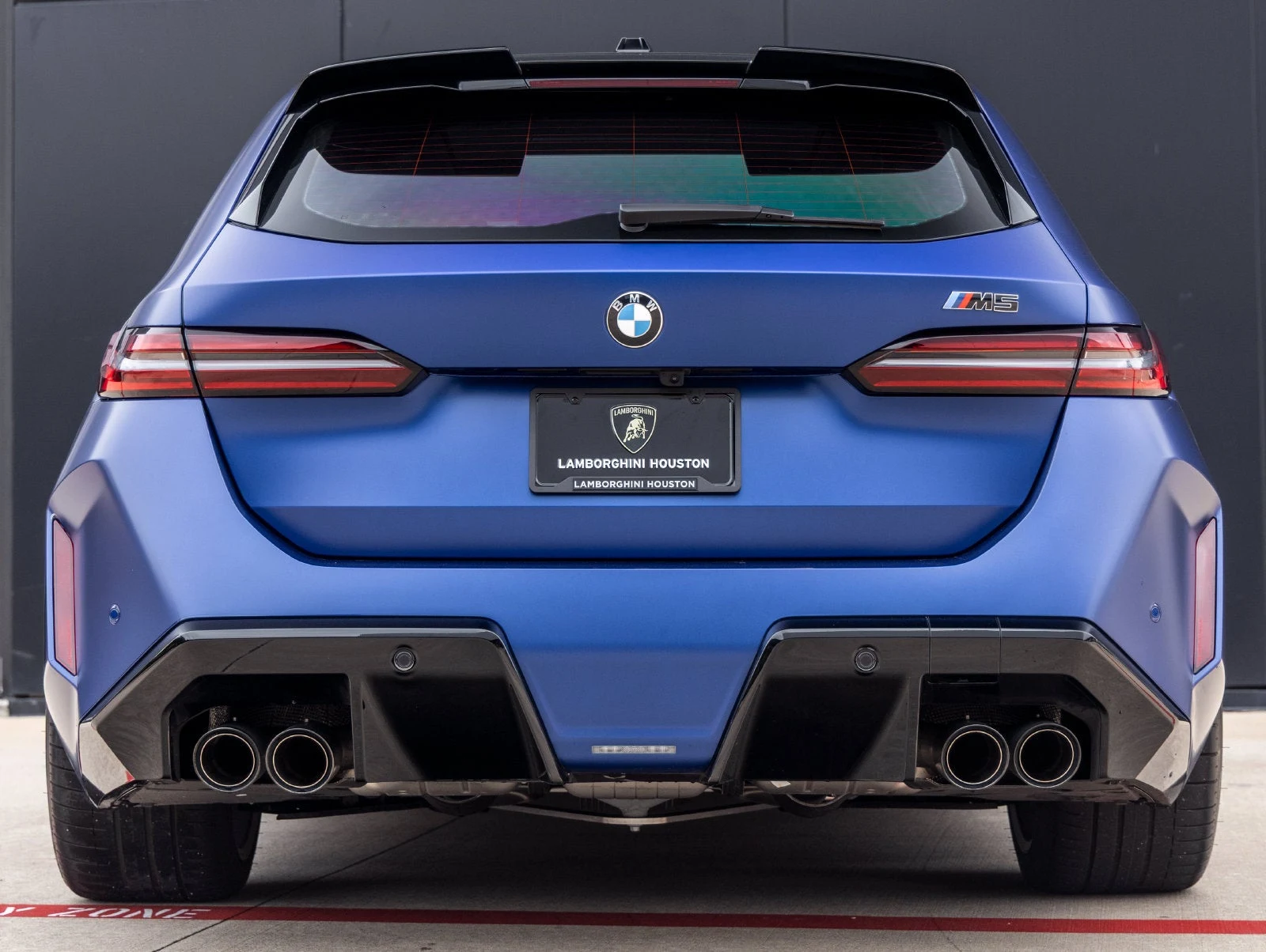 2026 BMW M5 Touring, rear three-quarter view, Marina Bay Blue Metallic