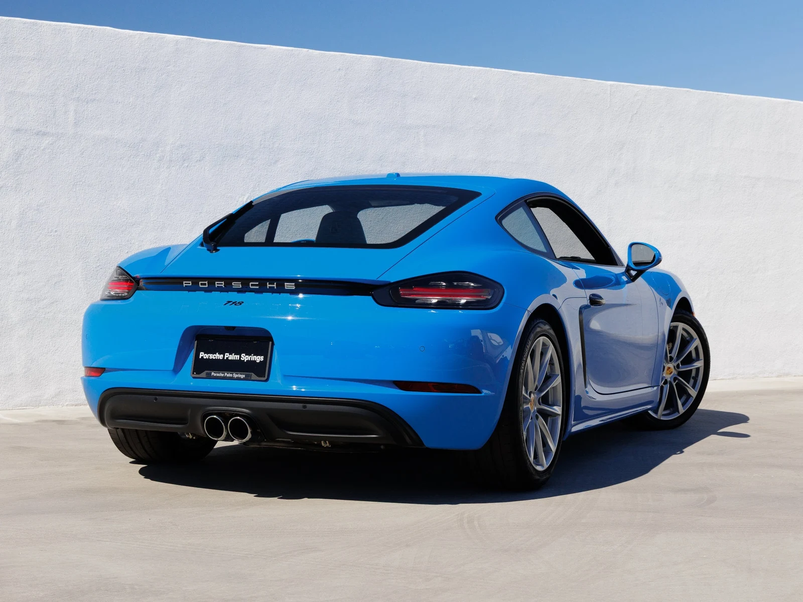2024 Porsche 718 Cayman, rear three-quarter view, Shark Blue