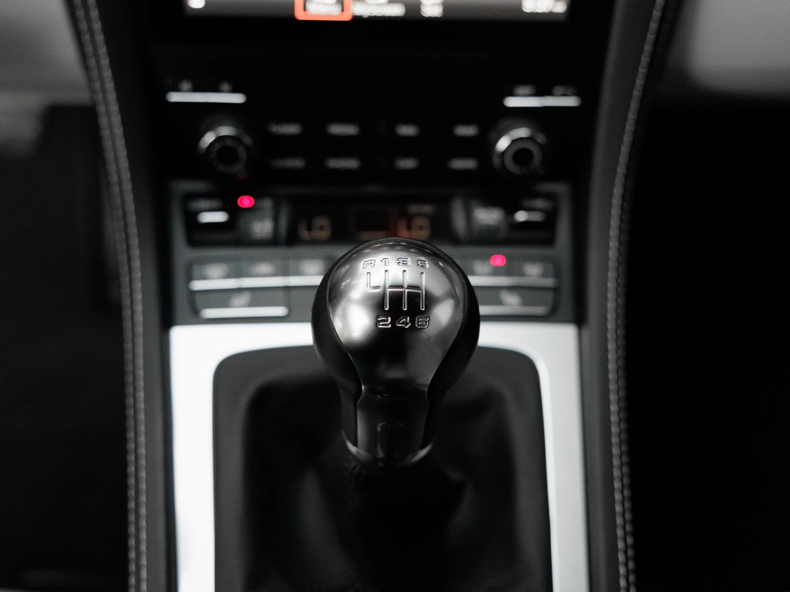 2024 Porsche 718 Cayman interior, center console, Black / Chalk leather