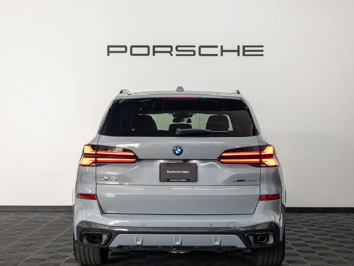 2026 BMW X5 xDrive50e, rear three-quarter view, Brooklyn Grey Metallic