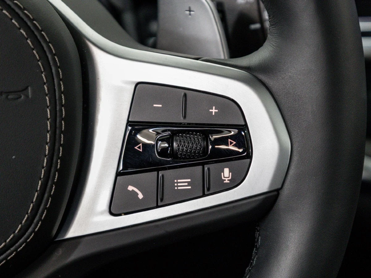 2026 BMW X5 xDrive50e interior, center console, Black Sensafin with decorative stitching