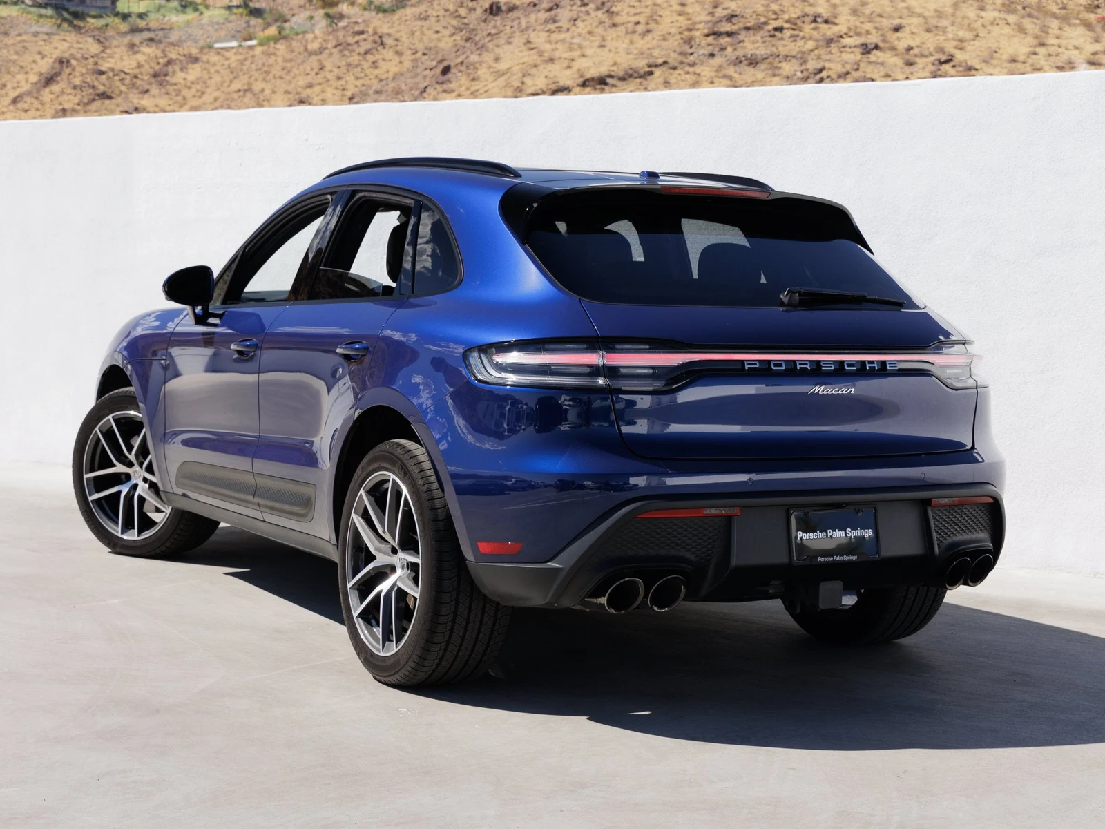 2026 Porsche Macan, rear three-quarter view, Gentian Blue Metallic