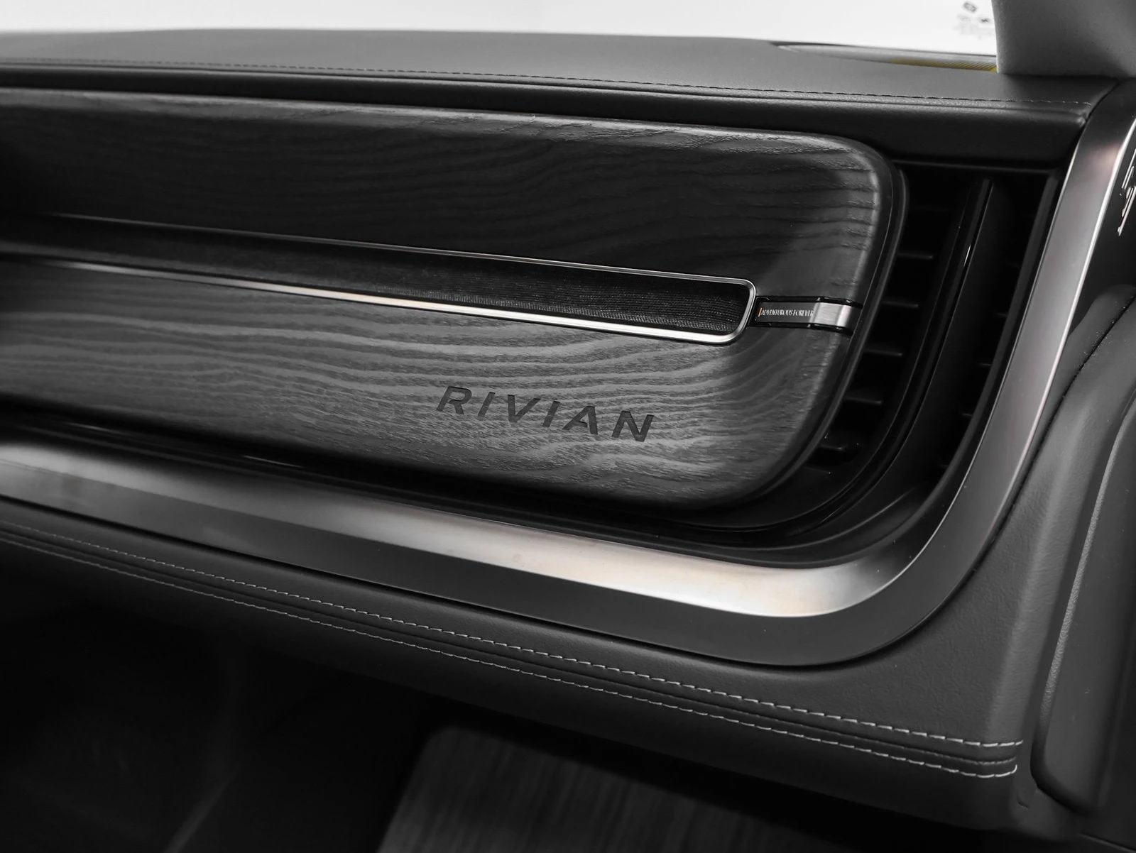 2023 Rivian R1S Adventure Quad-Motor Large Pack interior, door sill, Ocean Coast perforated vegan leather