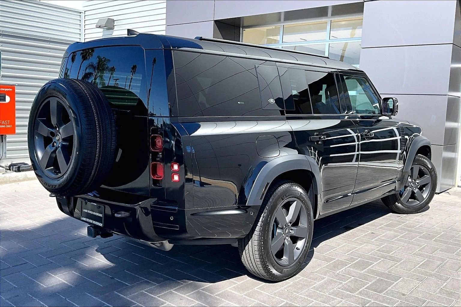 2023 Land Rover Defender 130 X-Dynamic SE, rear three-quarter view, Santorini Black Metallic