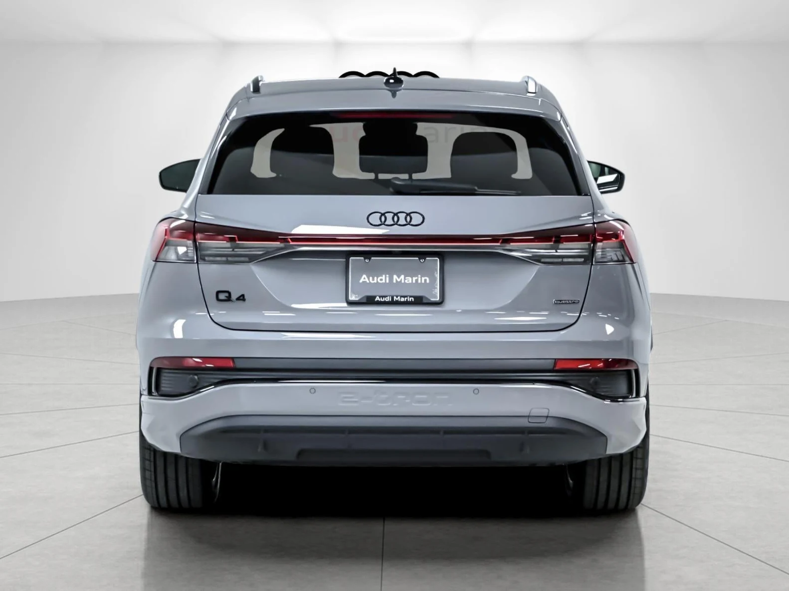 2024 Audi Q4 55 e-tron Prestige quattro, rear three-quarter view, Pebble Gray