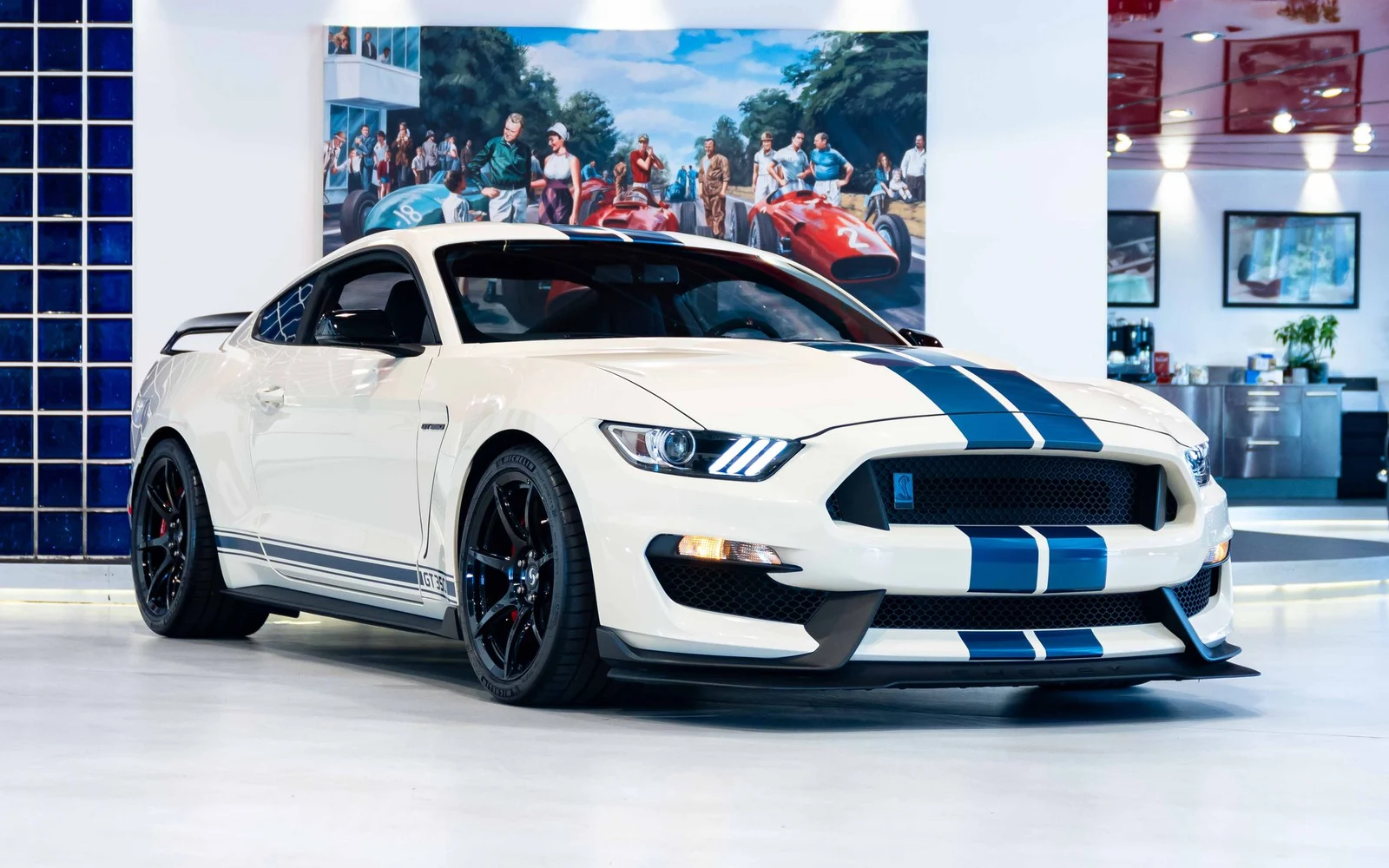 White Ford Mustang Shelby GT350R with blue stripes, full front three-quarter view