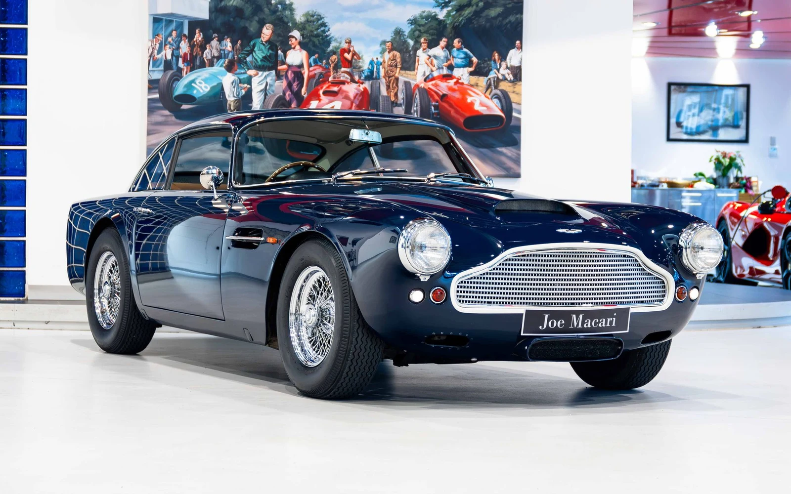 Dark blue Aston Martin DB4, full front three-quarter view