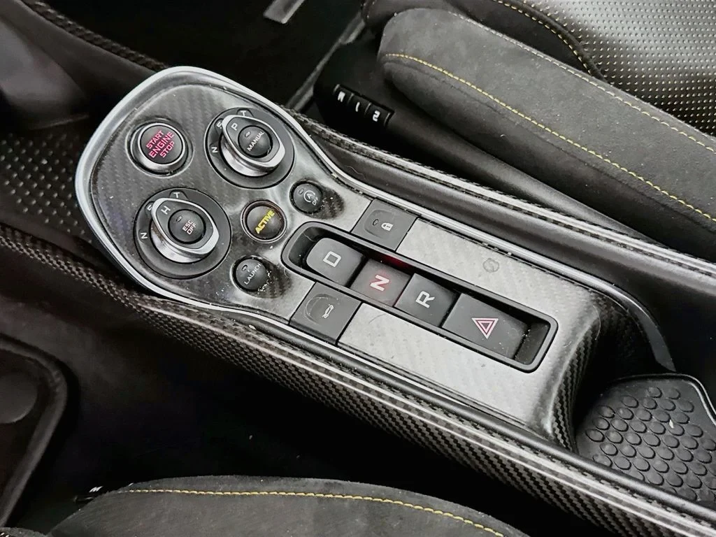 2019 McLaren 570S interior, center console, Carbon Black, with orange accents