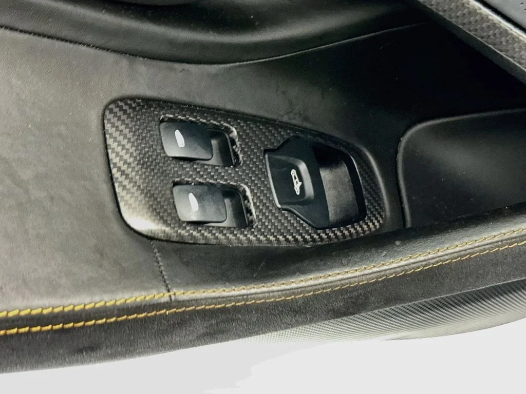 2019 McLaren 570S interior, door panel, Carbon Black, with orange accents