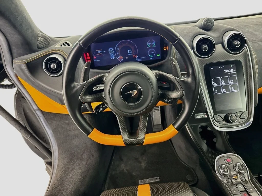 2019 McLaren 570S interior, dashboard, Carbon Black, with orange accents